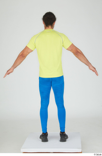 Simeon A poses black sneakers blue leggings dressed sports standing…